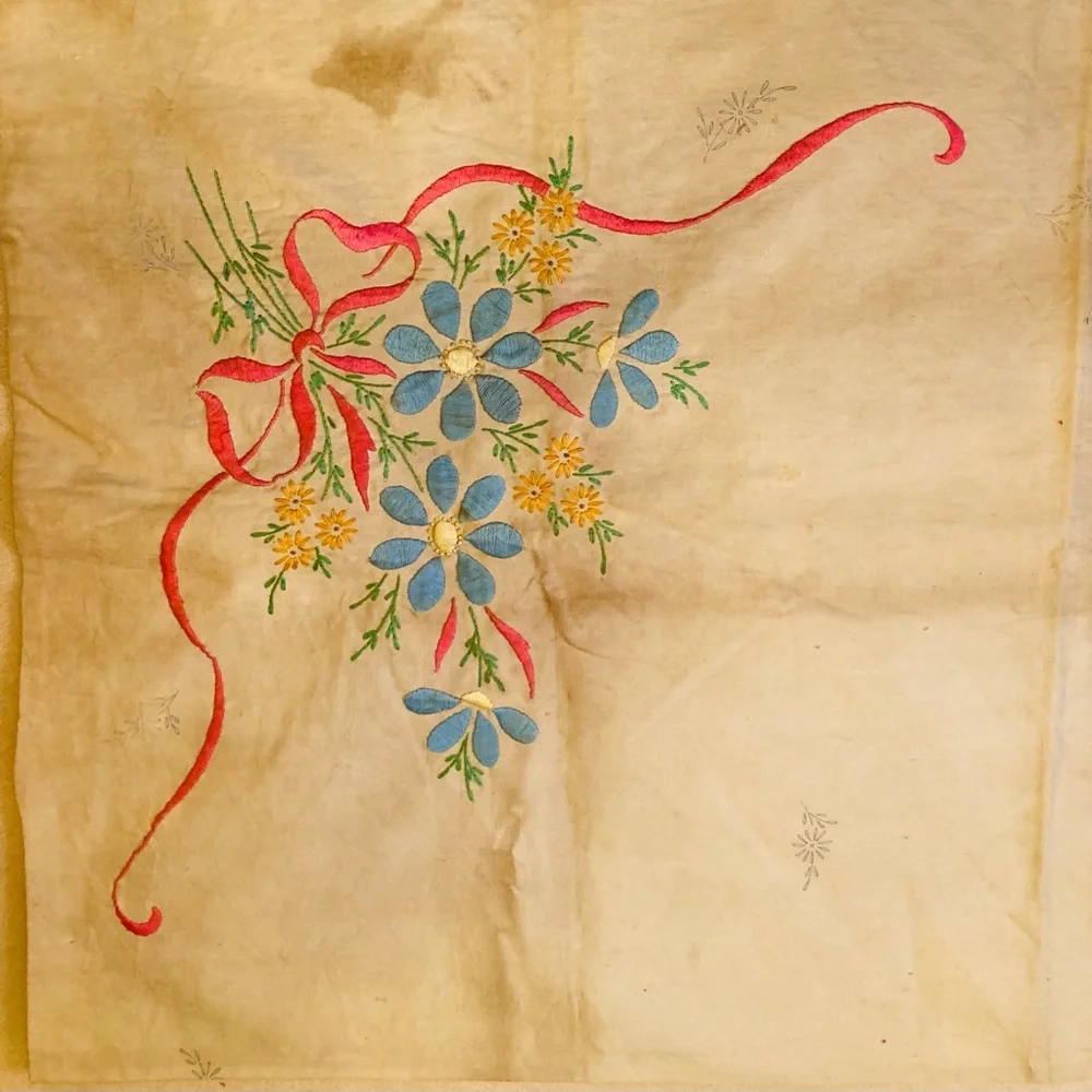 Vintage embroidery muslin, three corners begun, one ink outline blue pink red